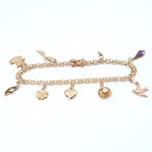 Armband X-länk Guld 18K 13,3g Längd 21cm Bredd 5mm med 9 berlocker varav 1 defekt