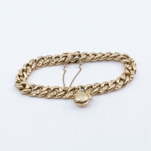 Armband Guld 18K 21,5g Längd 19,5cm Bredd 9mm, med en berlock och säkerhetskedja